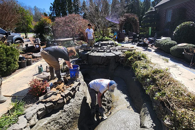 Morganton Ponds & Hardscapes team doing a pond cleaning