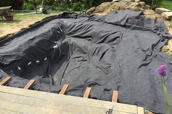 Empty koi pond representing part of how to fix a pond leak