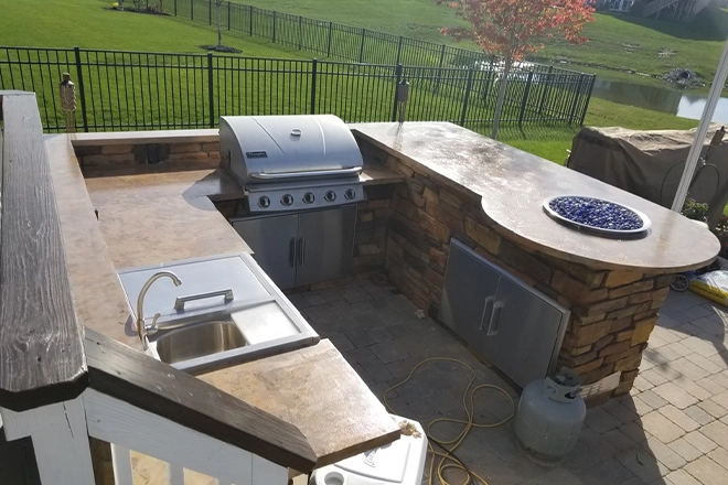 Outdoor kitchen with grill and sink and bar top Outdoor kitchen with grill and sink and bar top