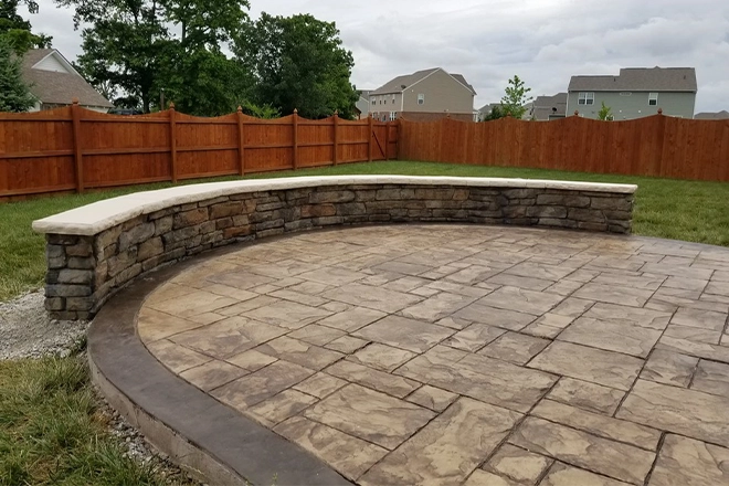 Circular flagstone patio with seating wall Circular flagstone patio with seating wall