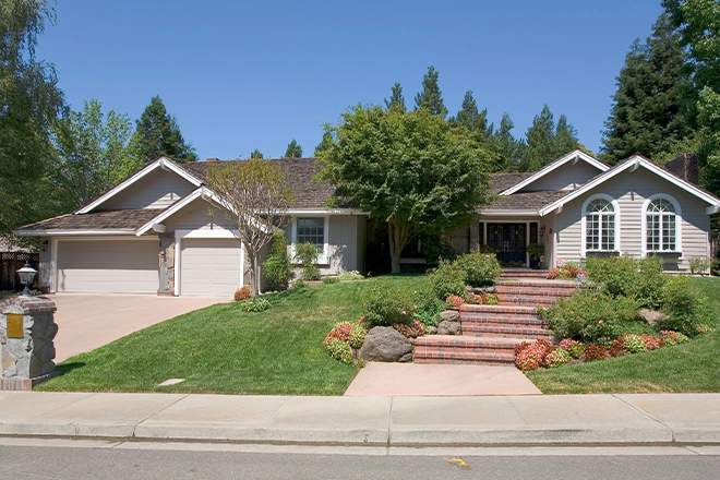 Hardscape front yard including driveway and brick steps with boulders and landscaping Hardscape front yard including driveway and brick steps with boulders and landscaping